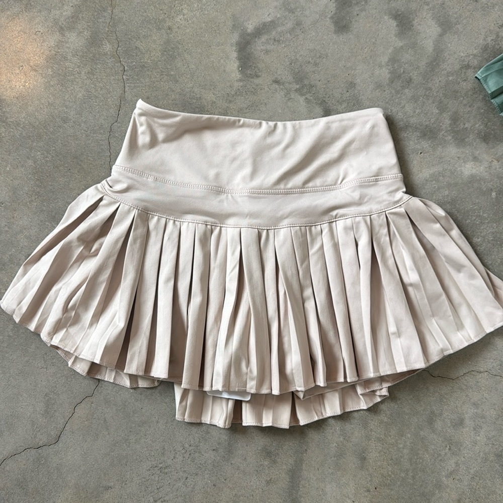 Gold hinge, nude tennis skirt